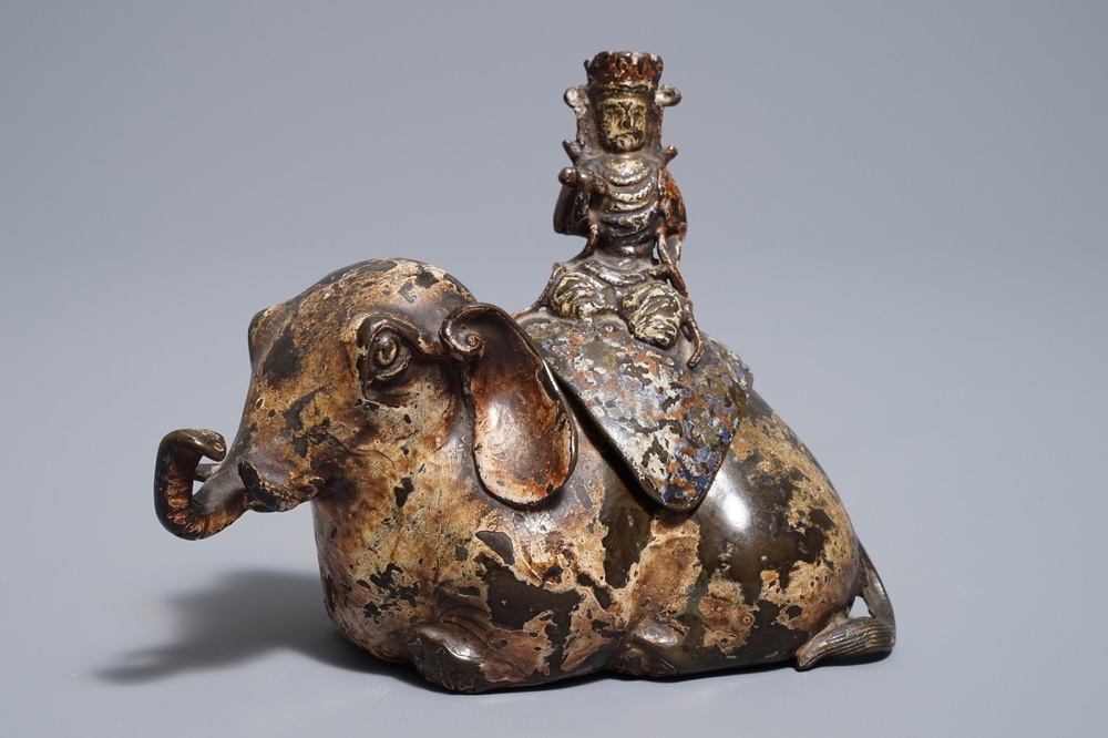 A Chinese bronze incense burner modelled as an elephant with female rider, Ming