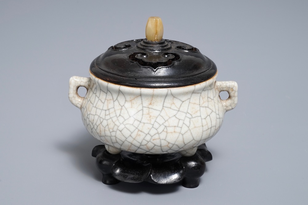 A Chinese ge-type crackle-glazed tripod censer and cover on stand, 19/20th