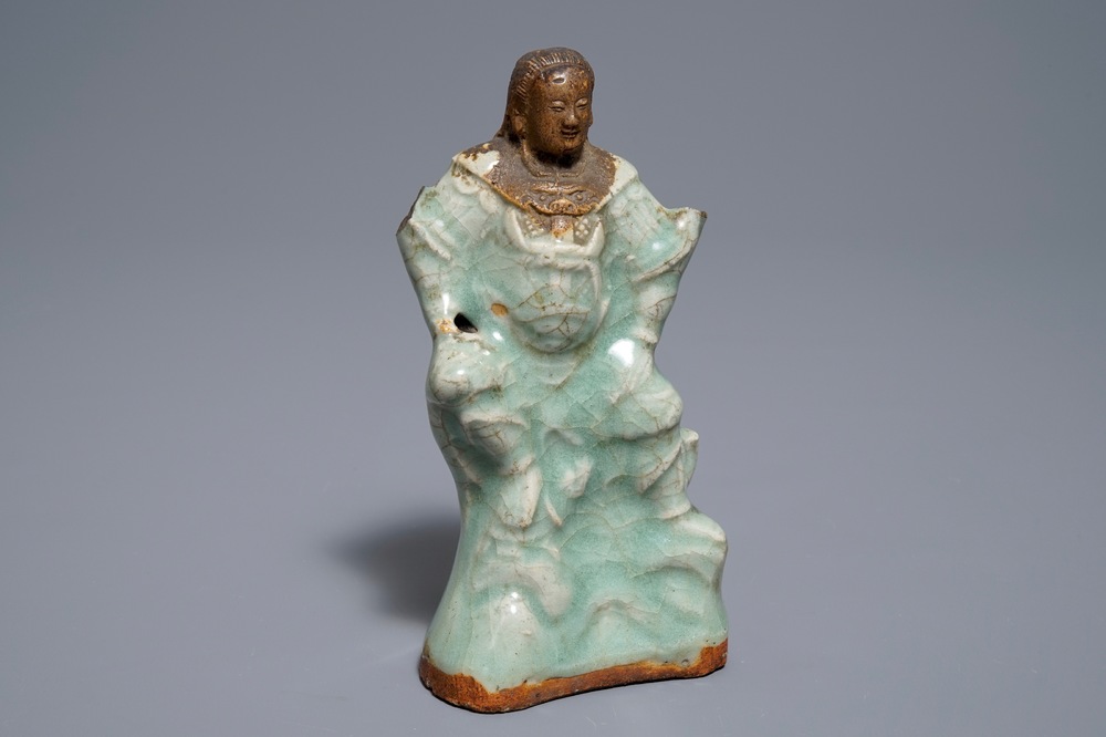 A Chinese Longquan celadon and biscuit figure of Zhenwu, Ming