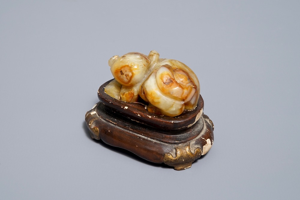 A Chinese celadon and russet jade carving of a tiger, Ming