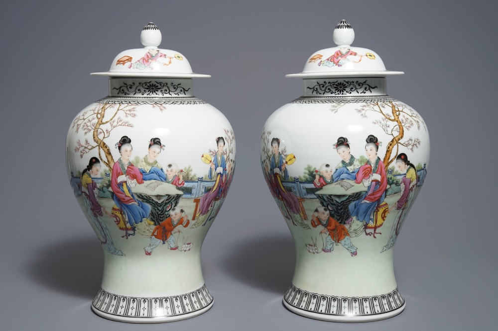 A pair of Chinese famille rose vases and covers, Qianlong mark, 20th C.