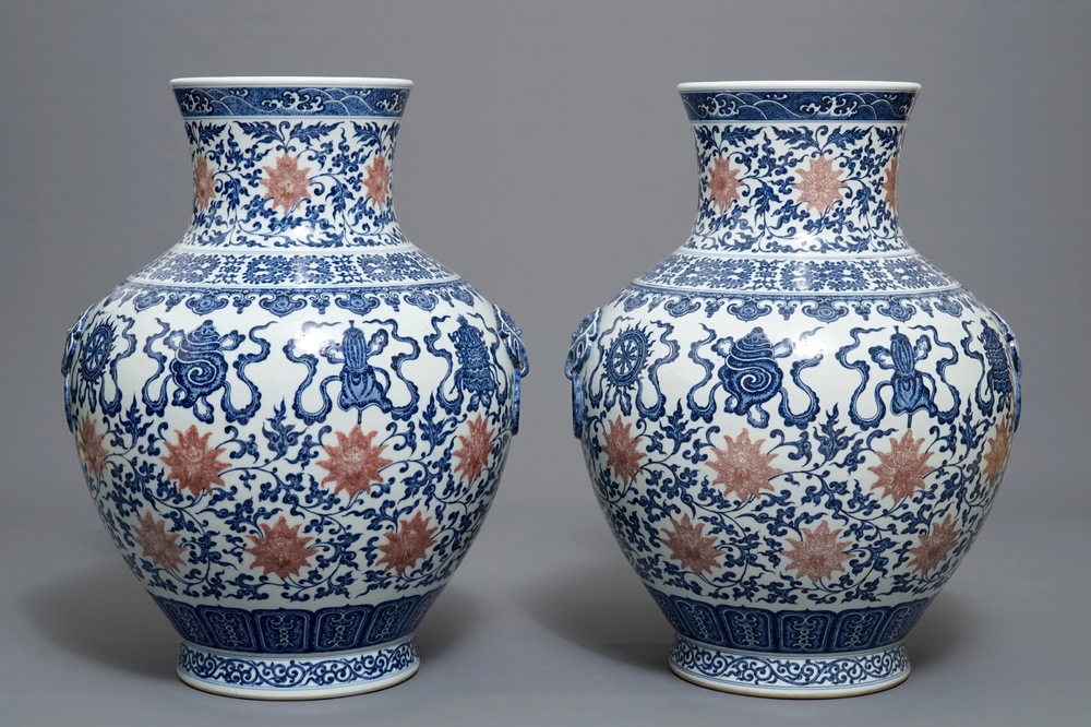 A pair of Chinese blue, white and iron red hu vases with taoist symbols, Qianlong mark, 20th C.