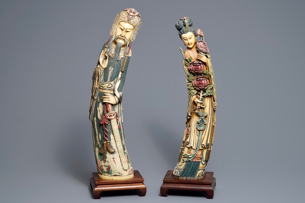 A pair of tall Chinese polychrome ivory figures on wooden bases, 19th C.