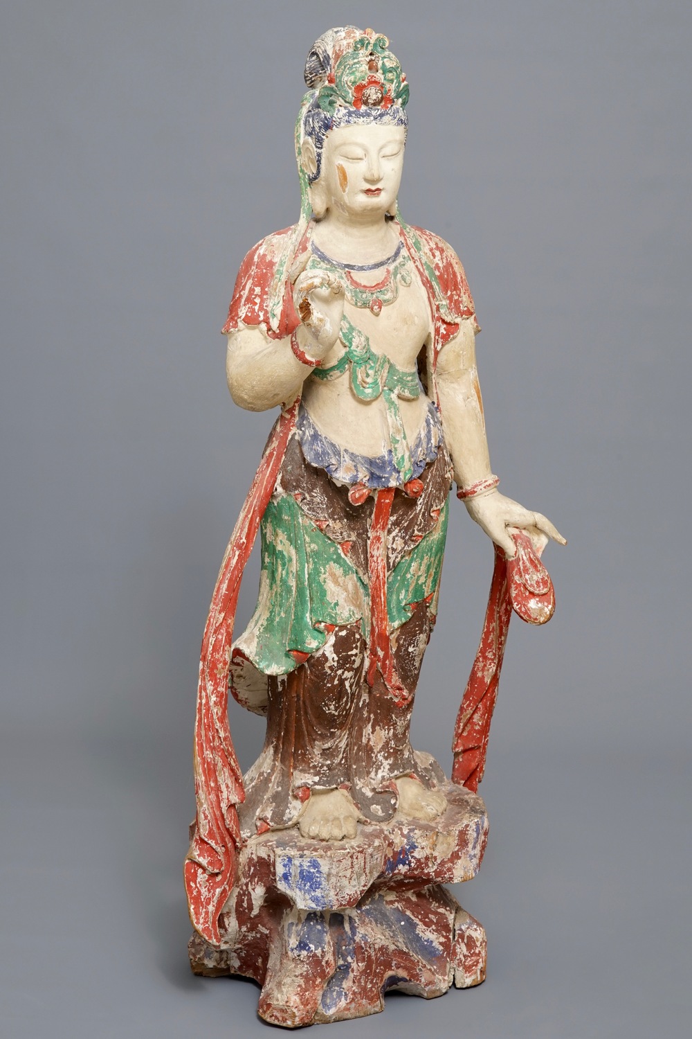 A tall Chinese painted and carved wood figure of Guanyin, 18/19th C.