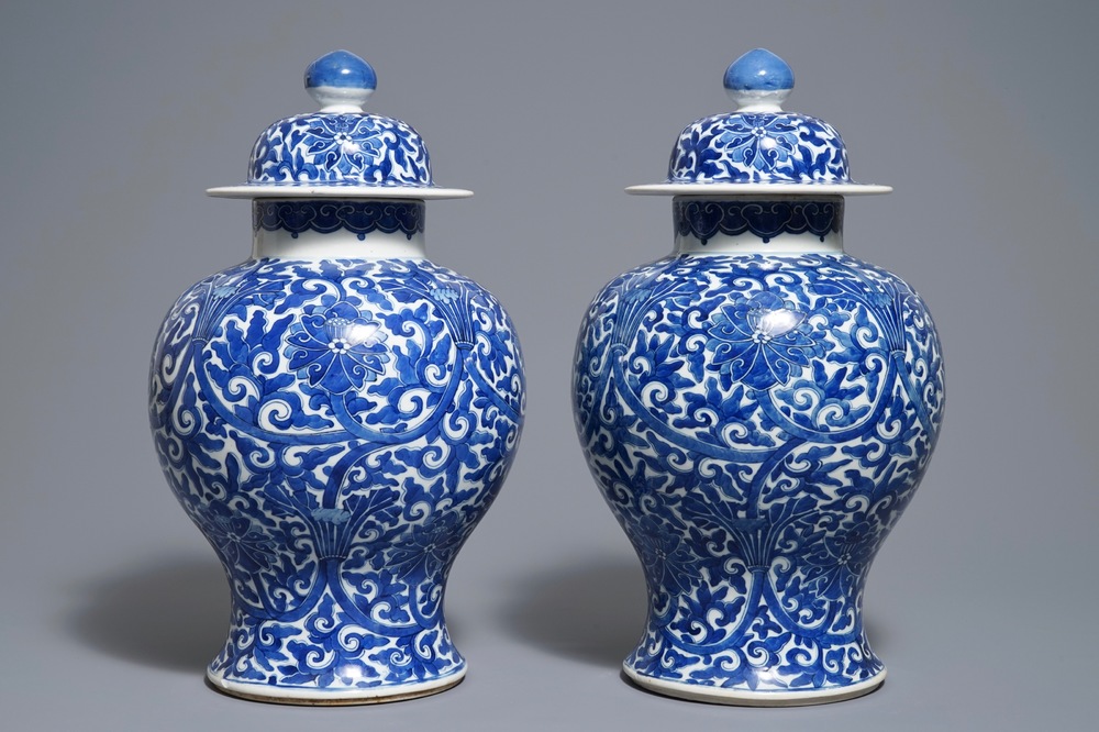 A pair of Chinese blue and white 'lotus scroll' vases and covers, 19th C.