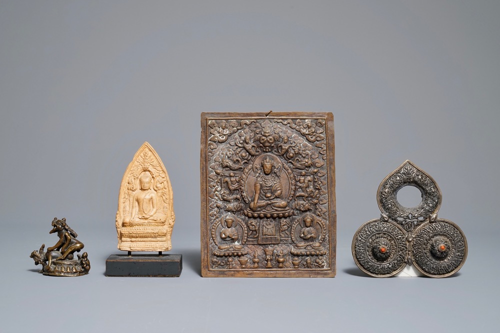 Two Tibetan votive plaques, a coral-inlaid silver amulet and a small bronze group, 18/19th C.