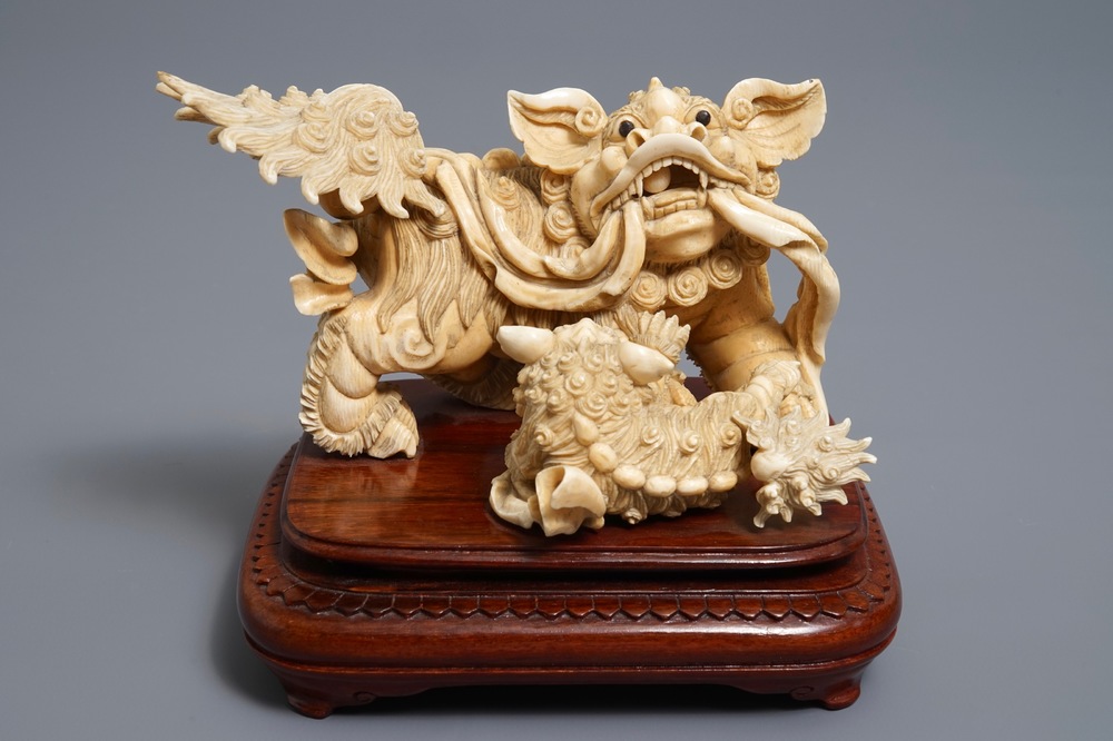 A Chinese ivory group of a Buddhist lion with cub, ca. 1920