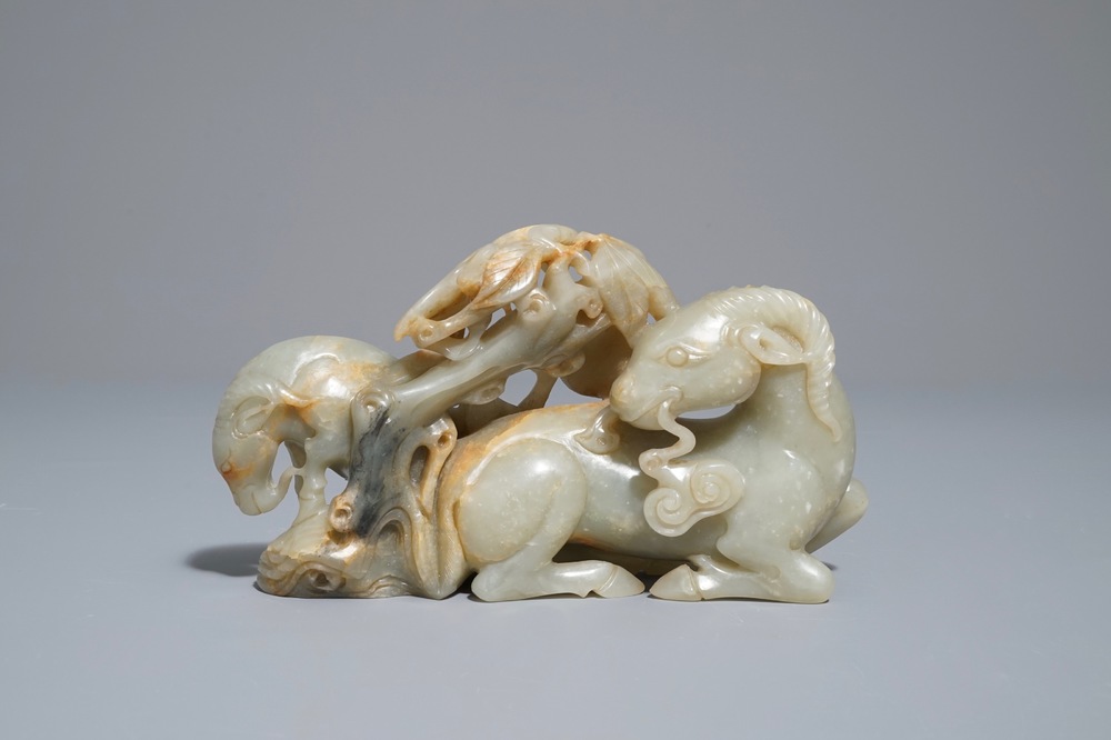 A Chinese celadon and russet jade 'rams' group, 18/19th C.