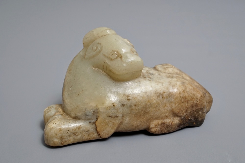 A Chinese pale greenish-grey and brown jade model of a mythical beast, Qing