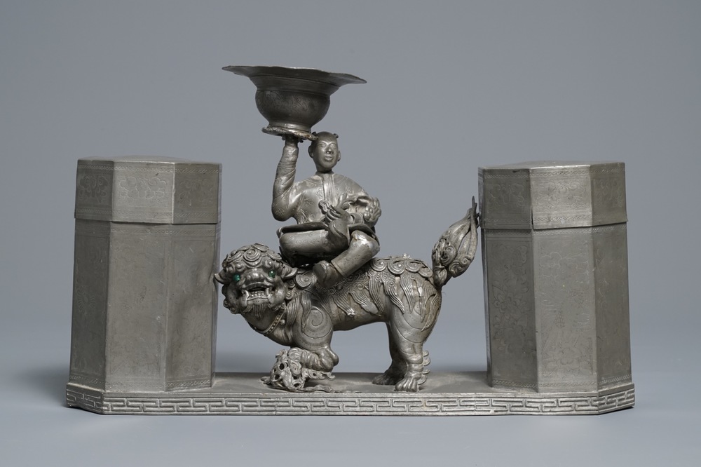 A large Chinese pewter double tea caddy with a central figure, impressed marks, 19th C.