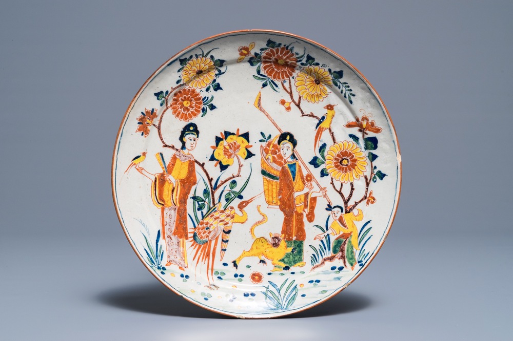 A polychrome Dutch Delft chinoiserie plate with figures around a tiger, 18th C.