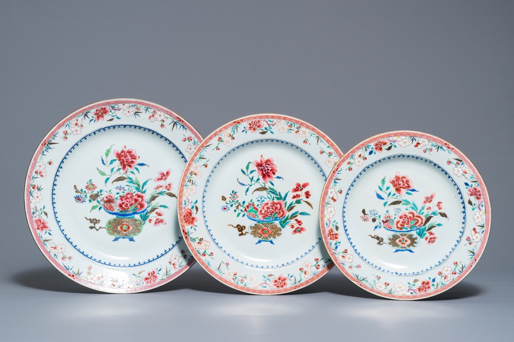 Three Chinese famille rose chargers with flower vases, Qianlong