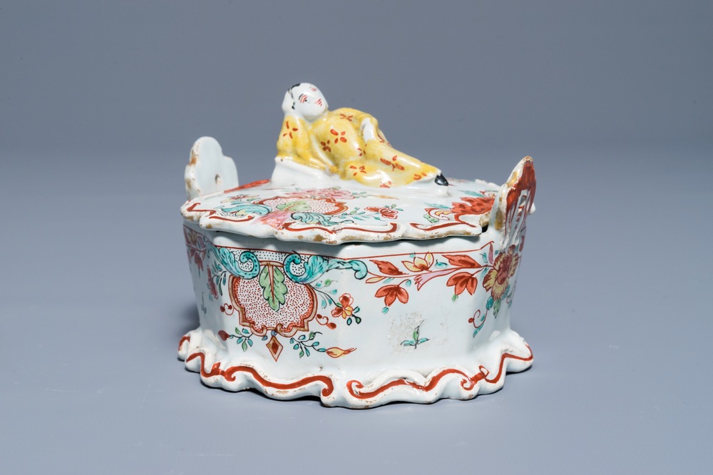 A polychrome Dutch Delft petit feu and dor&eacute; butter tub with a reclining Chinaman, 18th C.