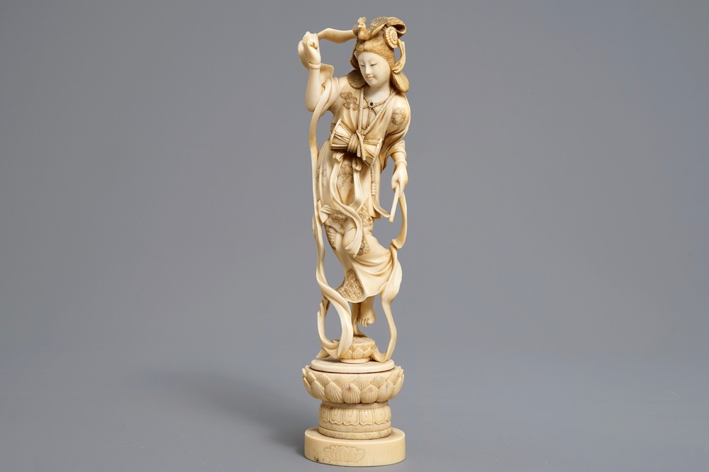 A Japanese carved ivory figure of a lady with a drum on a lotus throne, Meiji, 19th C.