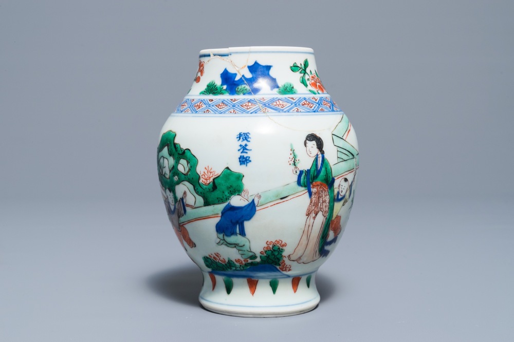 A Chinese wucai baluster vase with figures in a garden, Transitional period