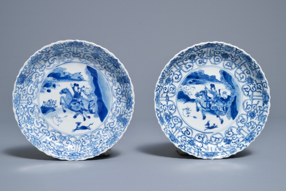 A pair of Chinese blue and white 'Mongolian hunting scene' plates, Chenghua marks, Kangxi