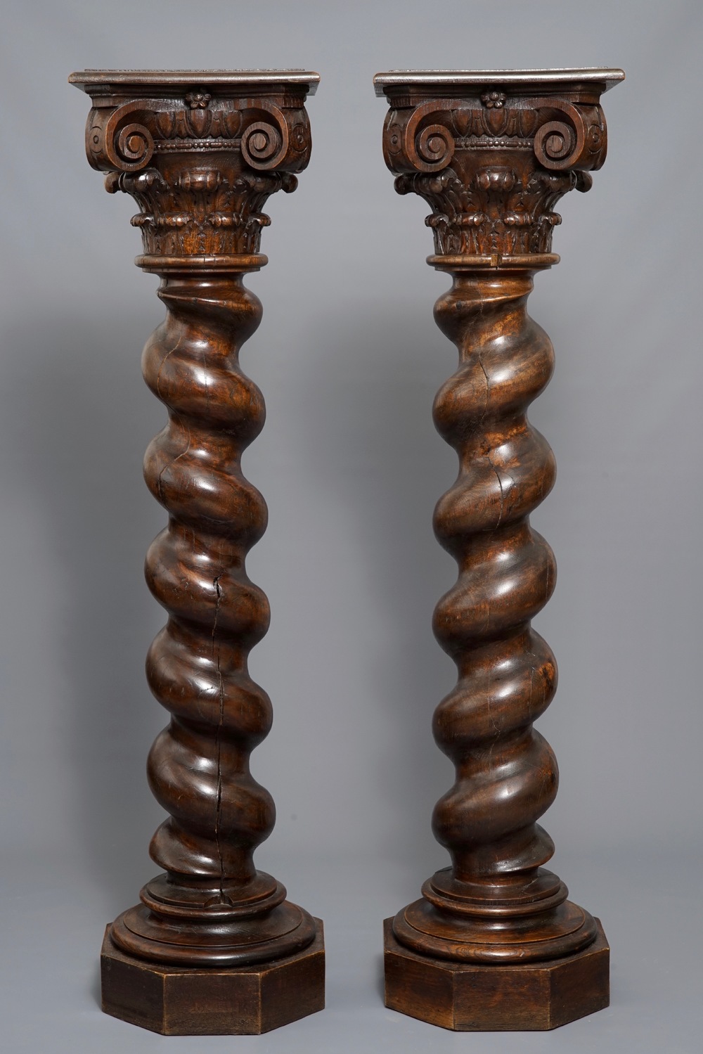 A pair of carved oak twisted pillars with Corinthian capitals, 18th C.