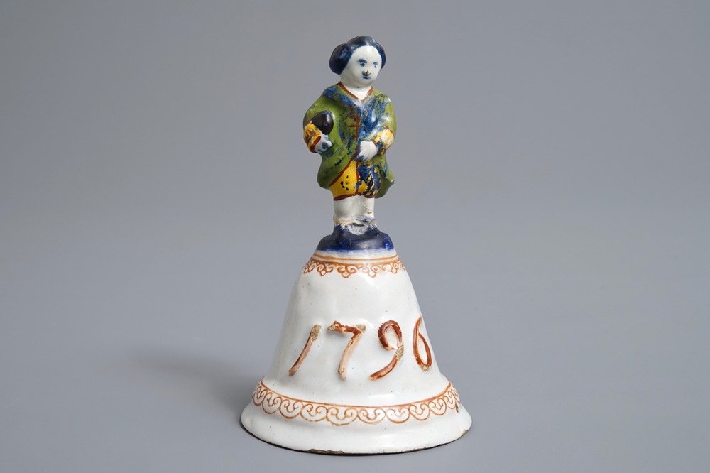 A polychrome Dutch Delft table bell with a nobleman, dated 1796