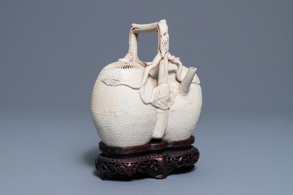 A Chinese biscuit 'conjoined peach' teapot and cover, Kangxi/Yongzheng