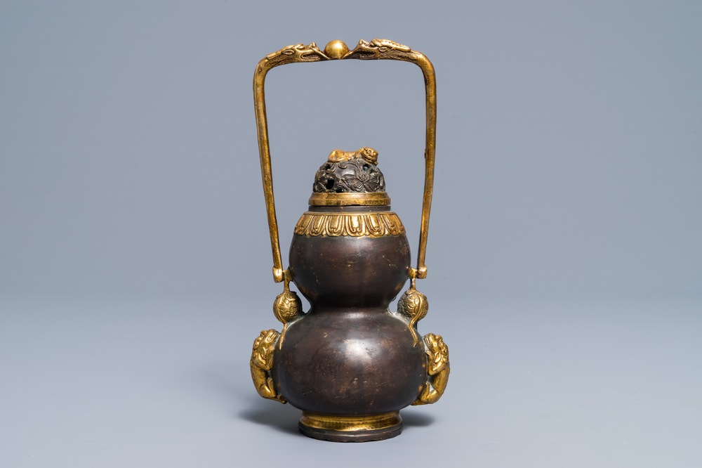 A Chinese parcel-gilt bronze double gourd hanging censer and cover, Kangxi mark, Qing