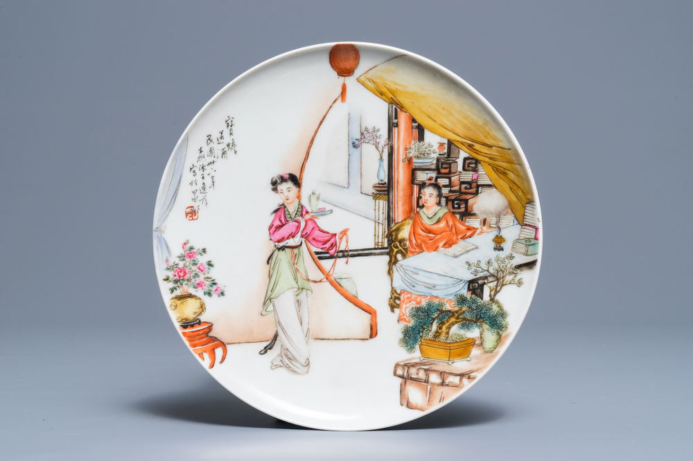 A Chinese famille rose plate with figures in an interior, Republic, 20th C.