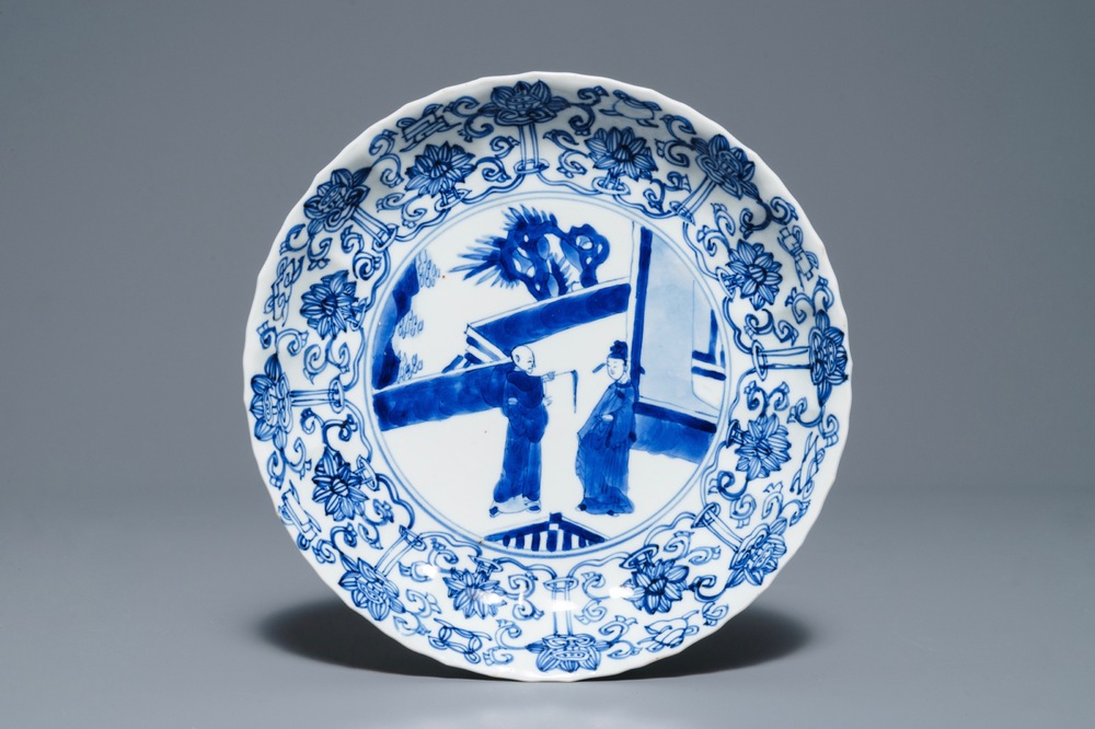 A Chinese blue and white moulded plate with figures on a terrace, Kangxi mark and of the period