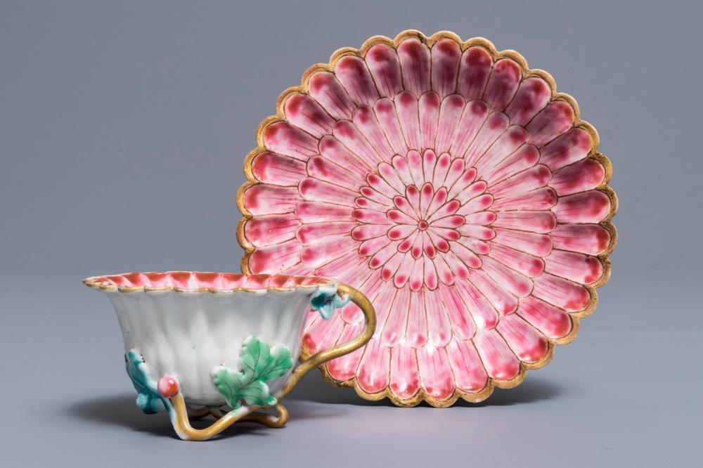 A Chinese famille rose lotus-shaped relief-decorated cup and saucer, Yongzheng