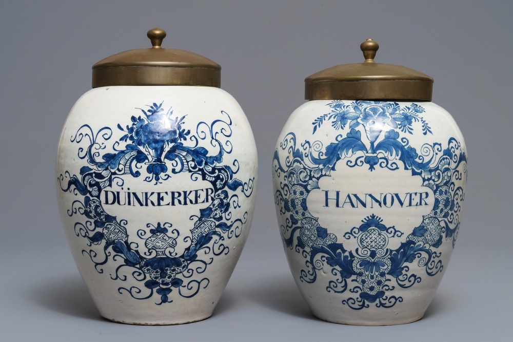 Two Dutch Delft blue and white tobacco jars with brass lids, 18th C.
