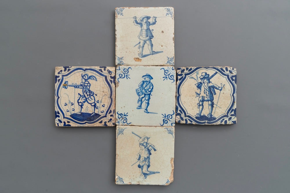 Vijf blauwwitte Delftse tegels met soldaten, w.o. met zichtbaar vuur, 17e eeuw