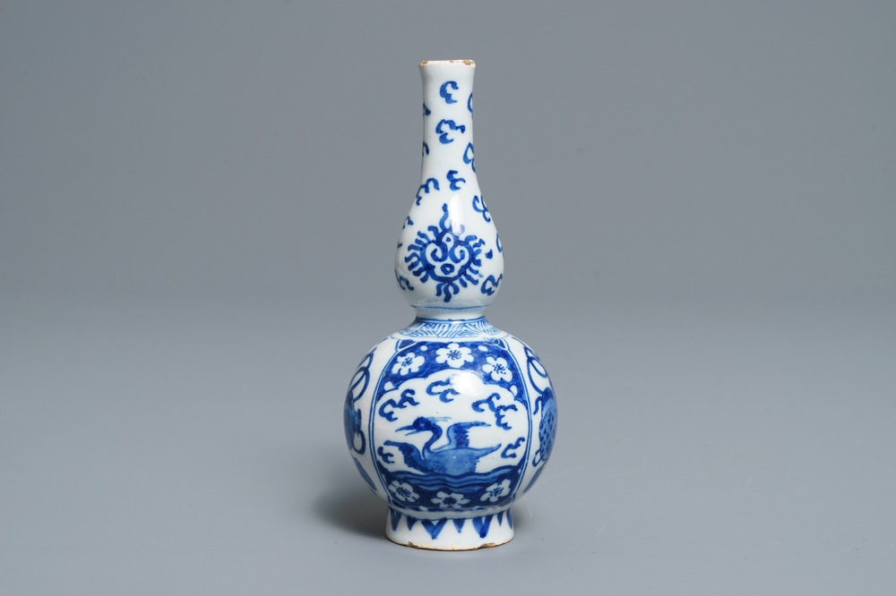 A Dutch Delft blue and white double gourd vase with swans and chinoiserie, late 17th C.