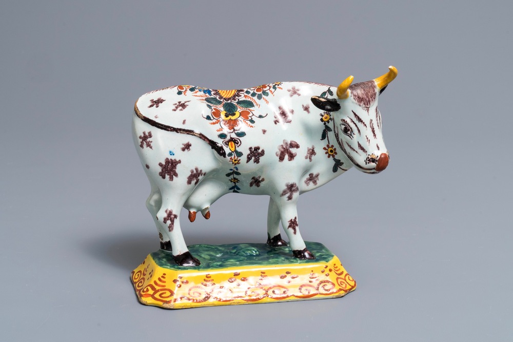 A polychrome Dutch Delft cow on base with frogs, 18th C.