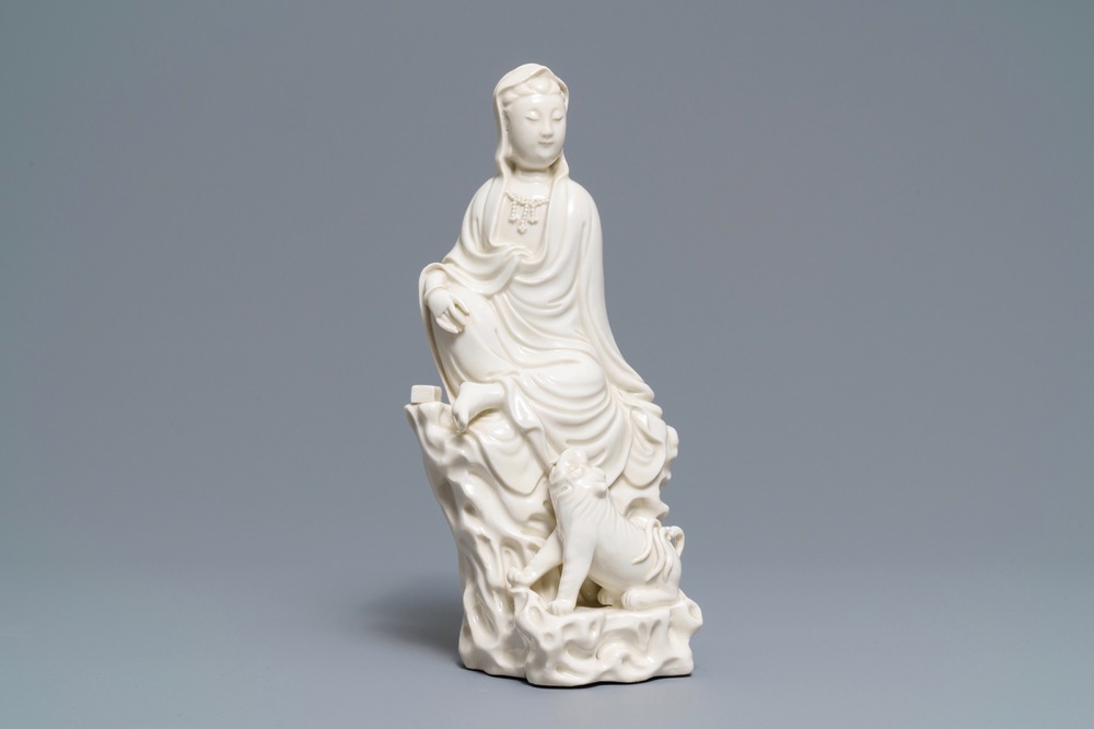 A Chinese Dehua blanc de Chine group of Guanyin with a tiger, 18/19th C.