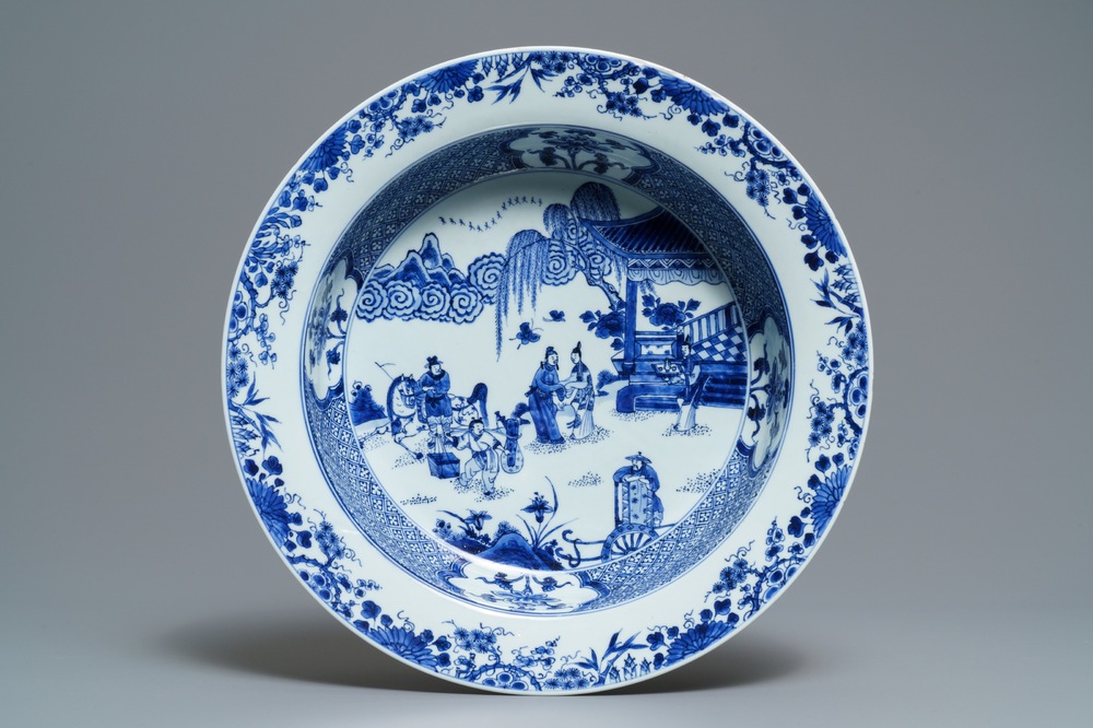 A deep Chinese blue and white dish with figures in a garden, Yongzheng