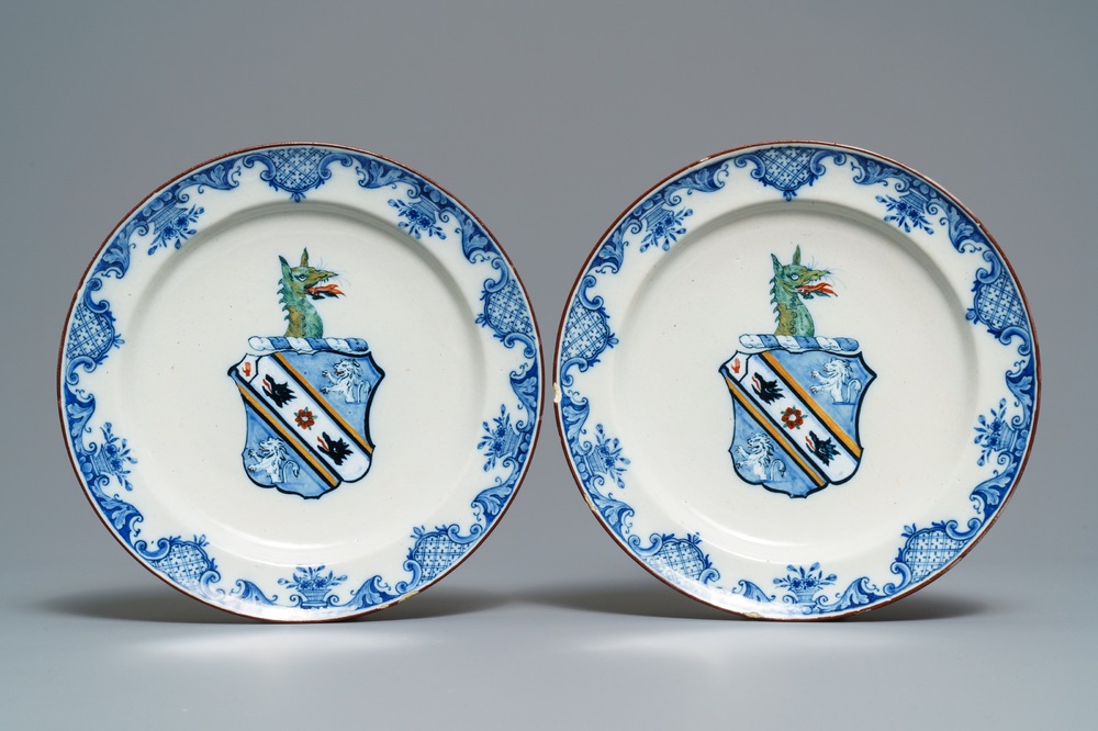A pair of polychrome Dutch Delft plates with the arms of Webster, 18th C.