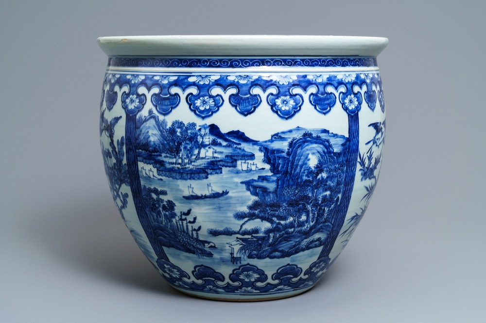 A Chinese blue and white fish bowl with landscape panels, 19th C.