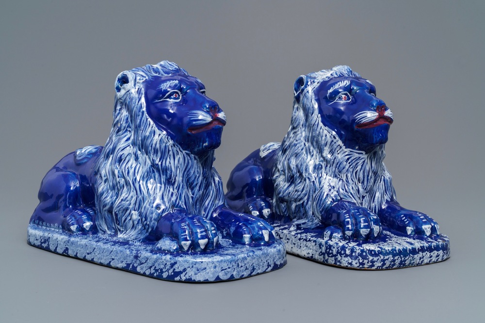 A pair of blue-ground models of recumbent lions, Saint-Omer, France, late 18th C.