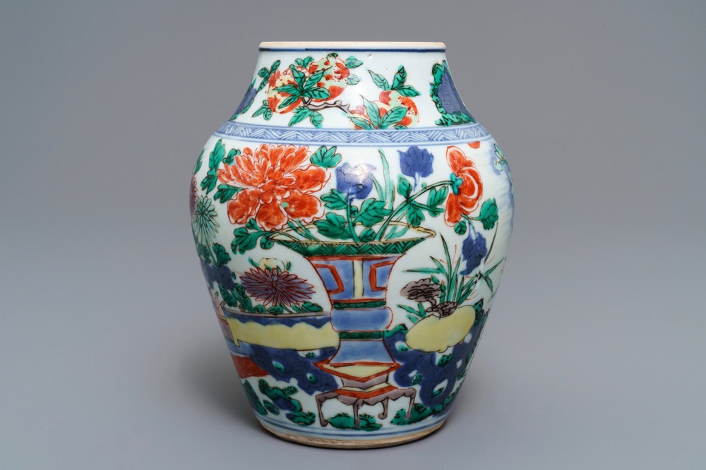A Chinese wucai vase with vases in a garden, Transitional period