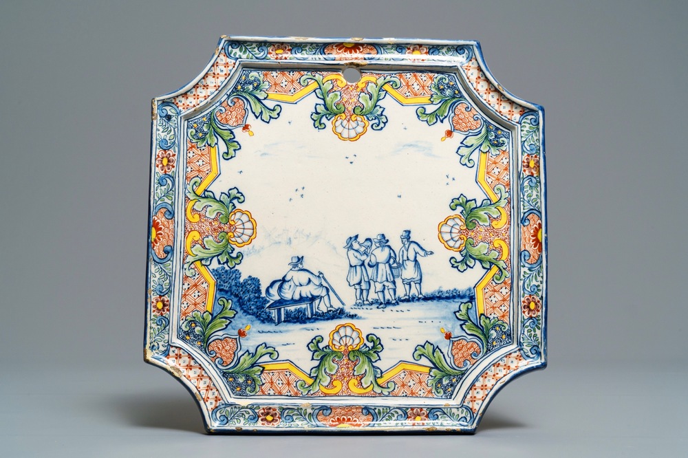 A Dutch Delft polychrome mixed technique plaque with figures in a landscape, 18th C.