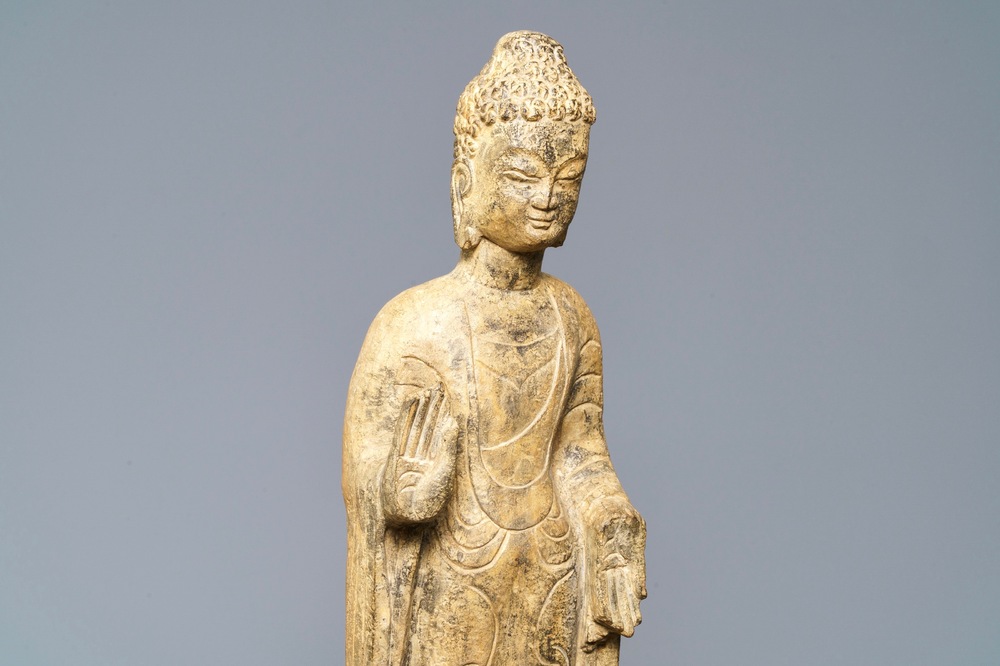 A Chinese carved stone figure of a standing Buddha, Ming or later