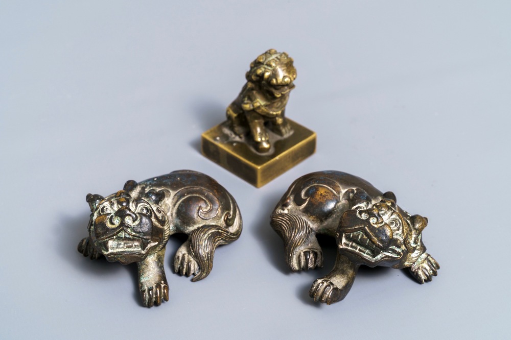 A pair of Chinese bronze 'lion' scroll weights and a seal, Ming and 18th C.