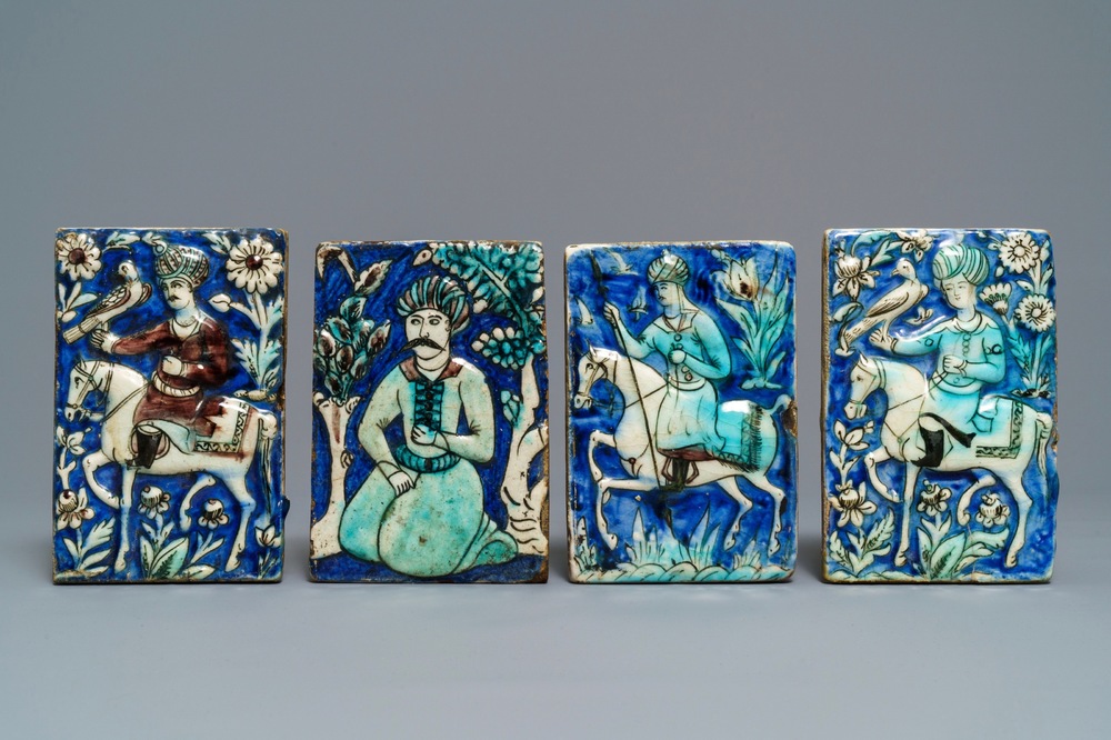 Four Qajar relief-moulded tiles with falconers, a soldier on horseback and a kneeling man, Iran, 19th C.
