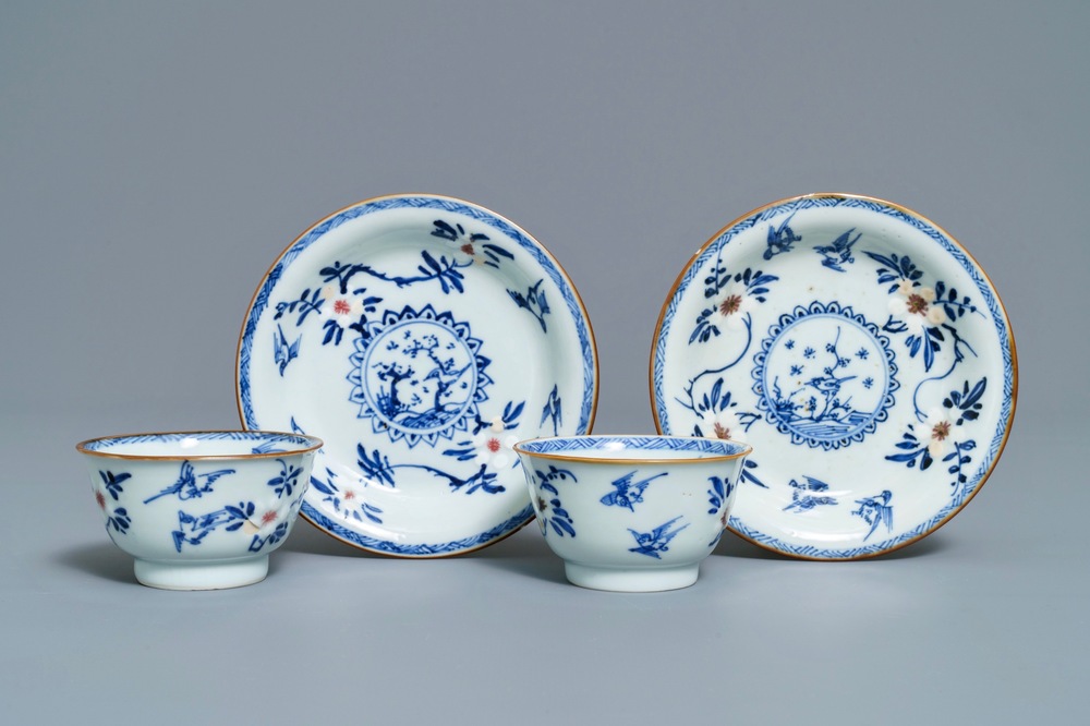 A pair of Chinese blue, white and underglaze red cups and saucers, Kangxi