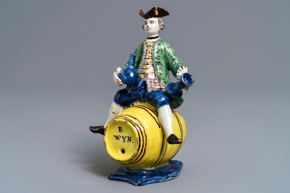 A polychrome Dutch Delft figure of a man on a barrel, 18th C.