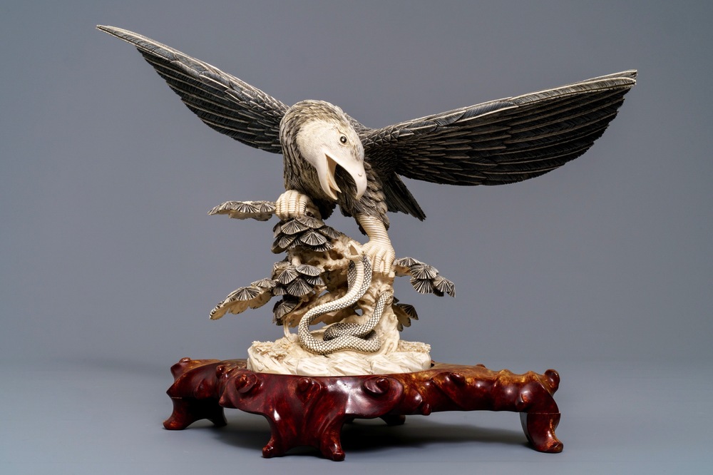 A Chinese carved ivory model of an eagle with a snake, ca. 1930