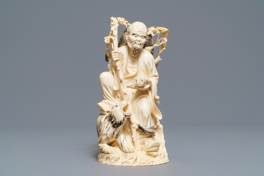 A Chinese ivory group of a sage with a tiger, 19/20th C.