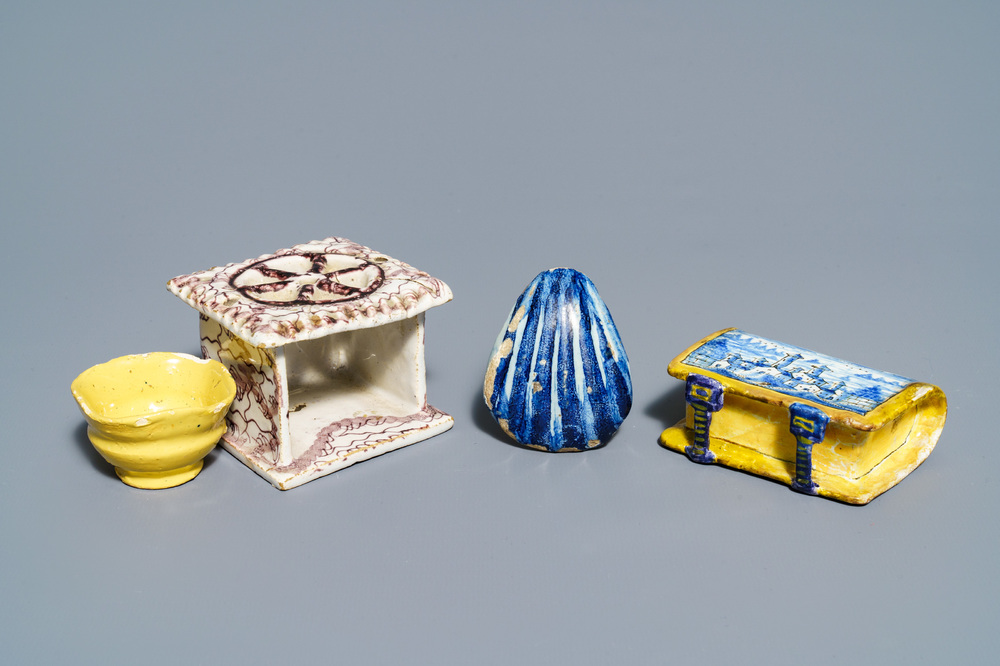 A manganese Dutch Delft miniature stove, a blue and white shell and a French book-shaped handwarmer, 18th C.