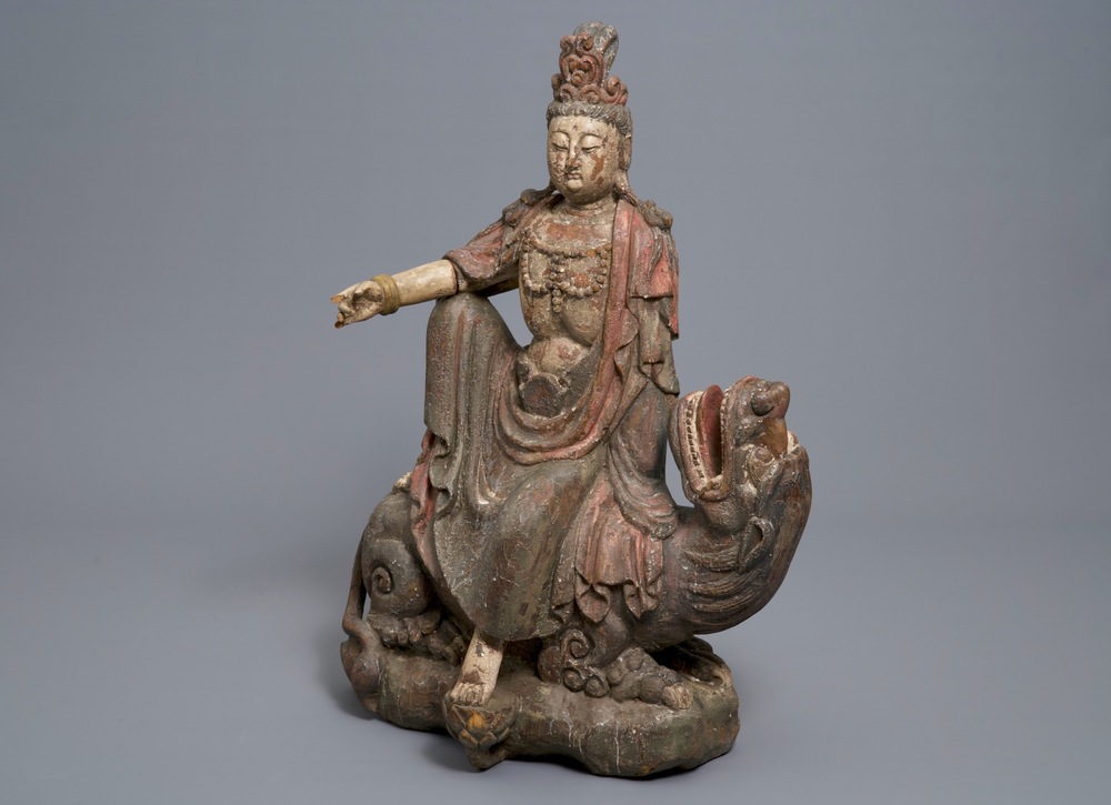 A Chinese polychrome wood group of Guanyin on a dragon, 18th C.