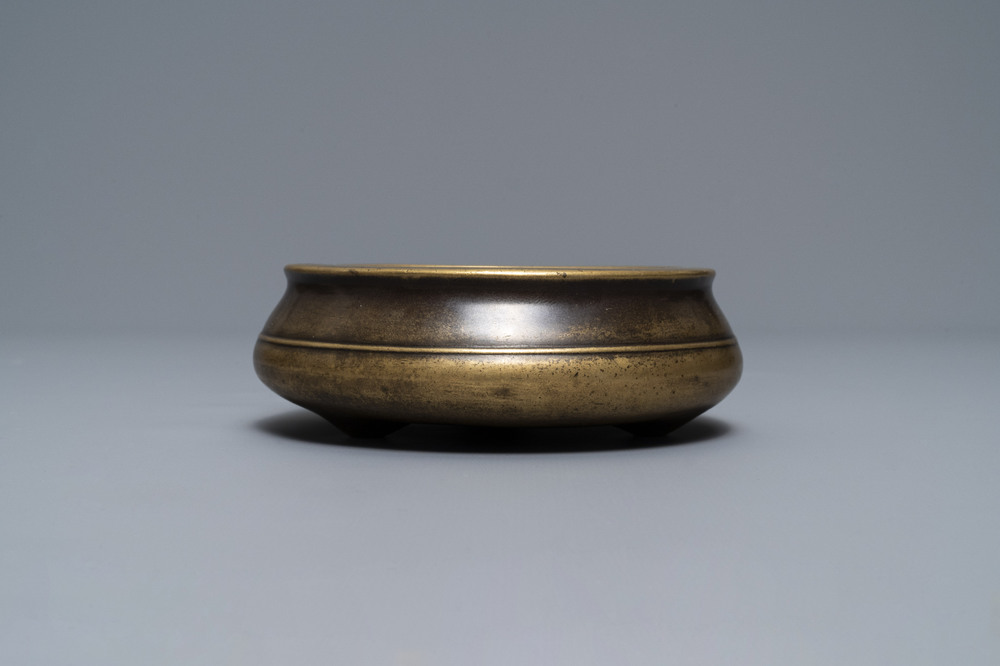 A flat Chinese bronze tripod censer, Xuande mark, 18th C.