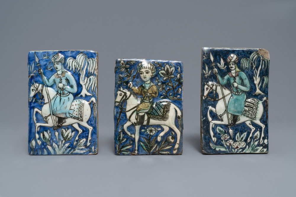 Three Qajar relief-moulded tiles with soldiers on horseback, Iran, 19th C.