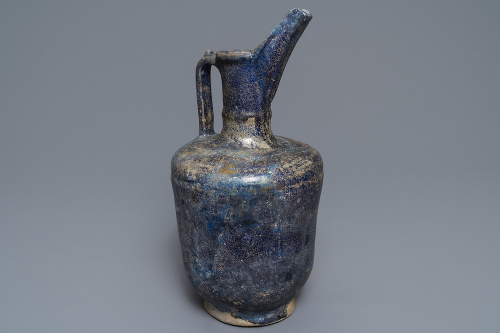 A blue-glazed Islamic pottery jug, Kashan, Iran, 13th C.